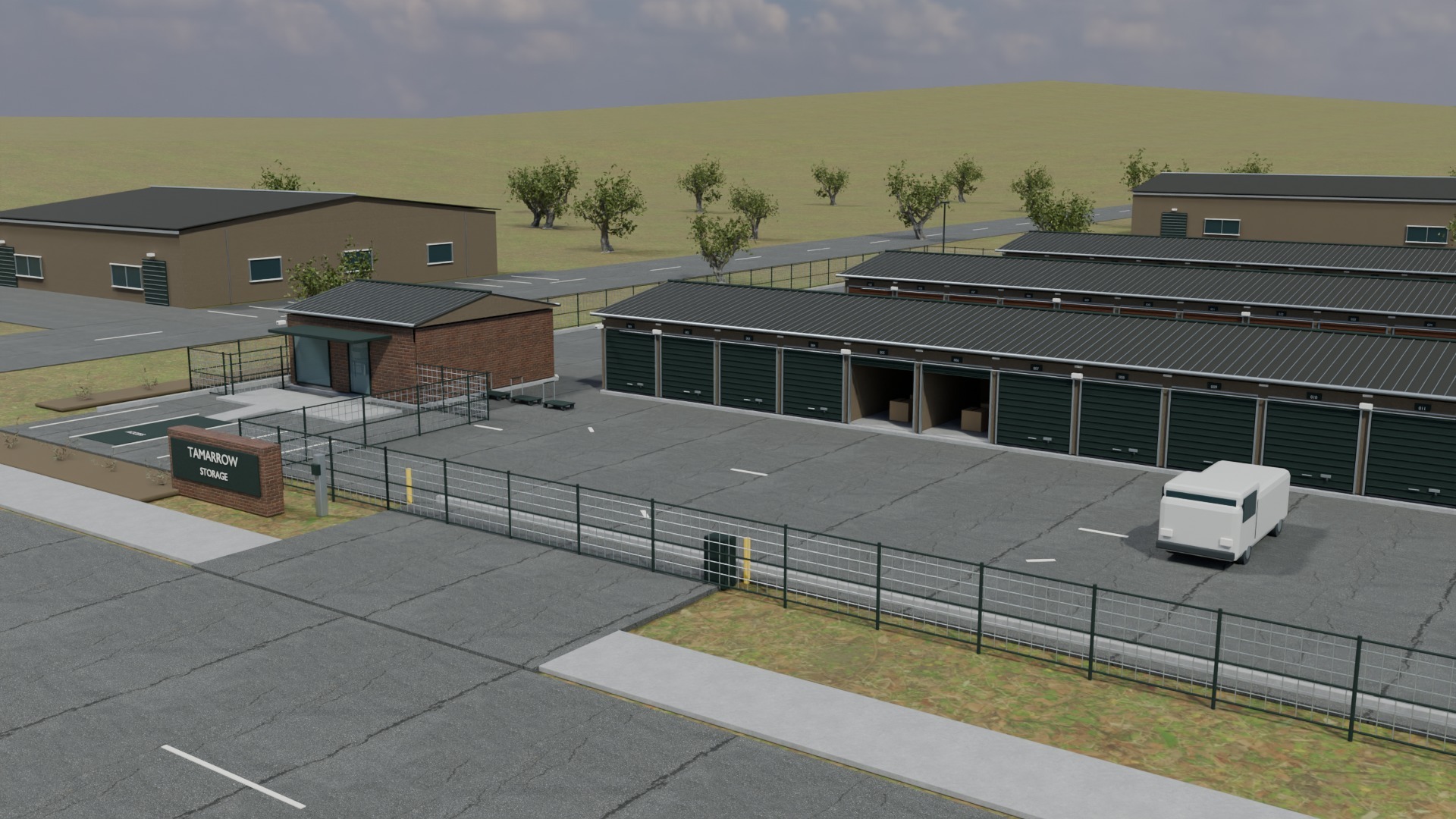 The Tamarrow Storage masonry sign and perimeter fence in front of three rows of storage units with dark green and rust-colored doors.