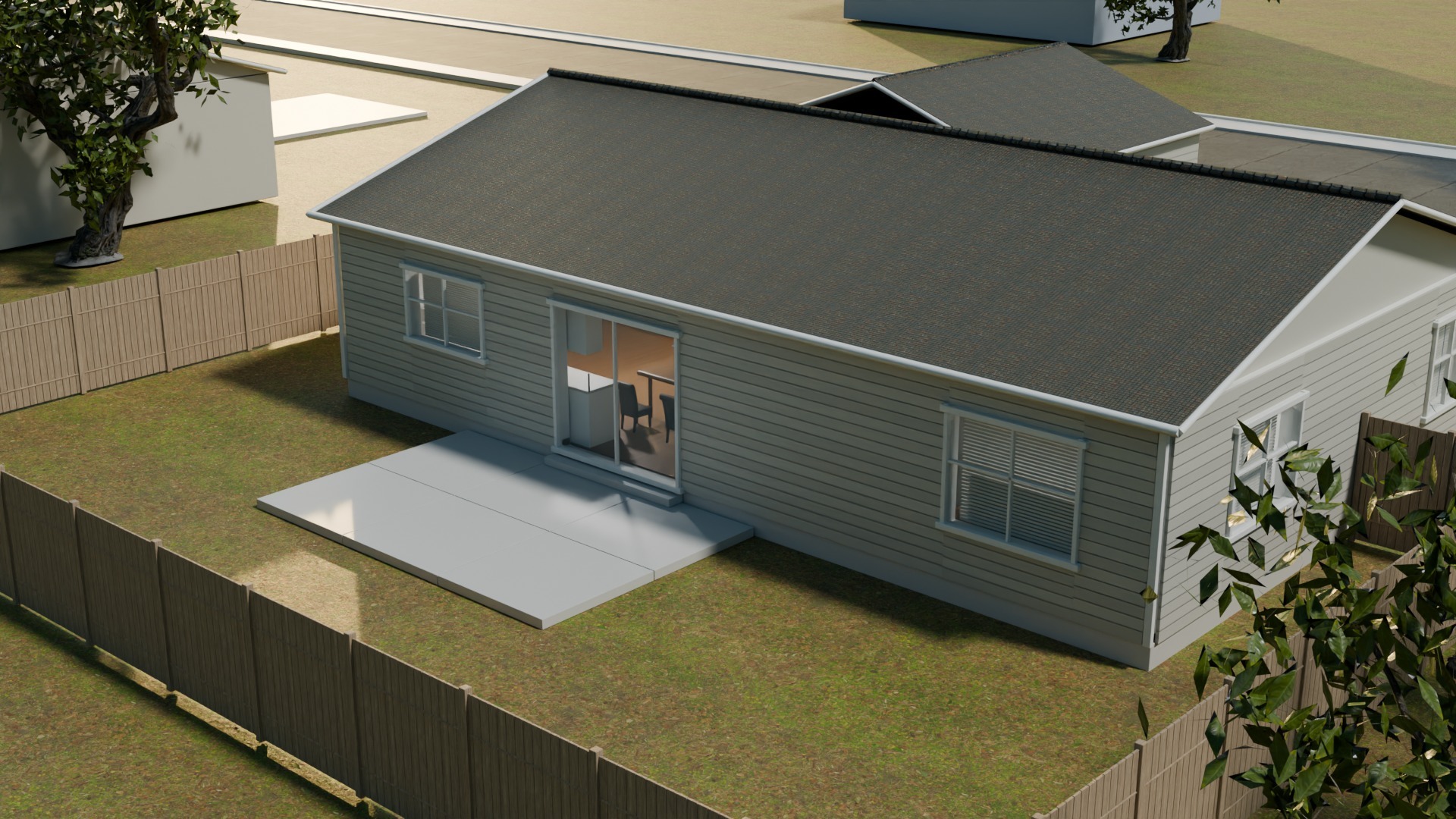Rear view of the single-story house, concrete patio and wood fence.